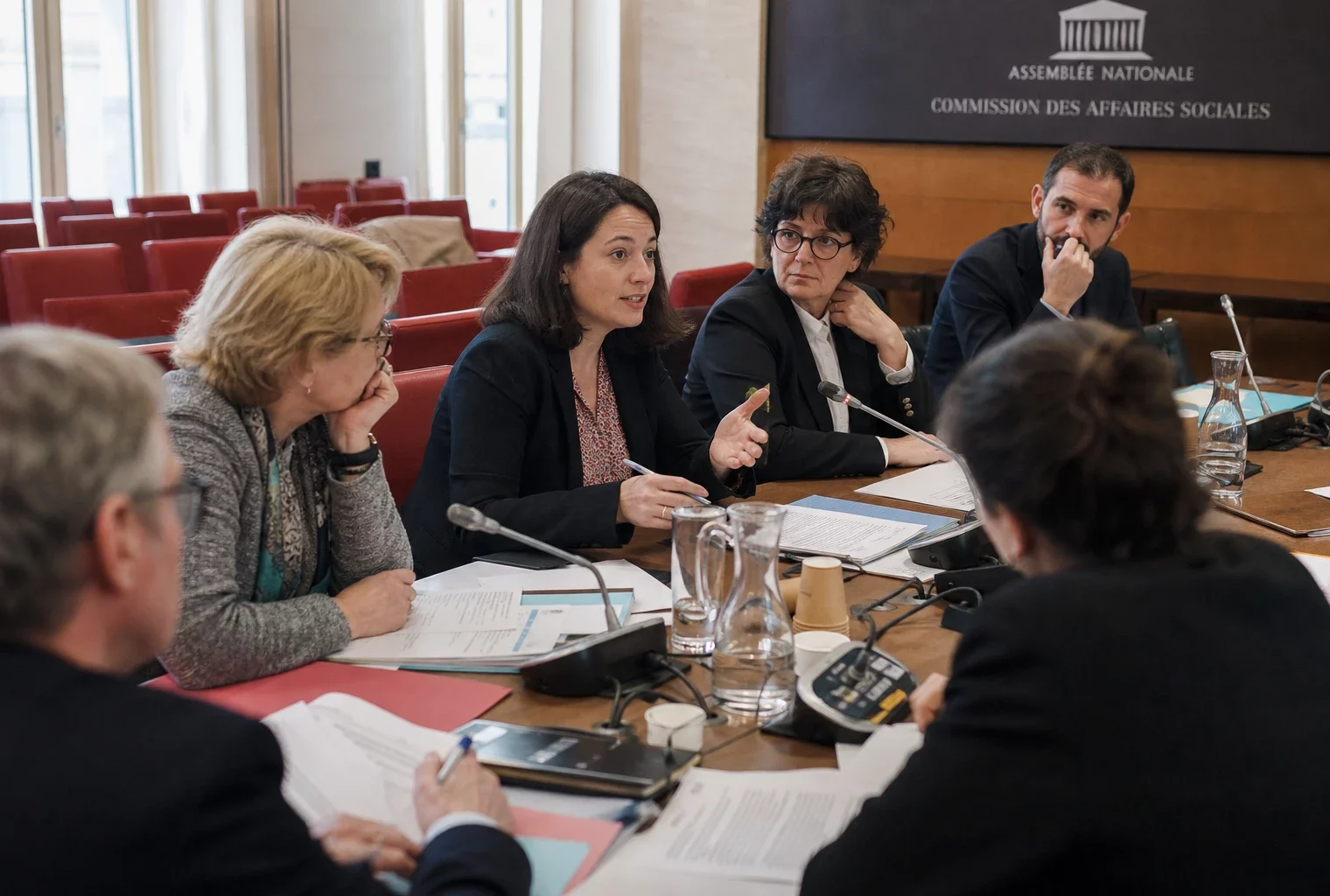 Réunion à l’Assemblée nationale sur la protection des enfants, avec députés et acteurs associatifs autour d’une table.