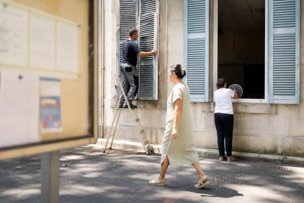Des agents d’une école publique française ventilent une salle pendant une journée de canicule.
