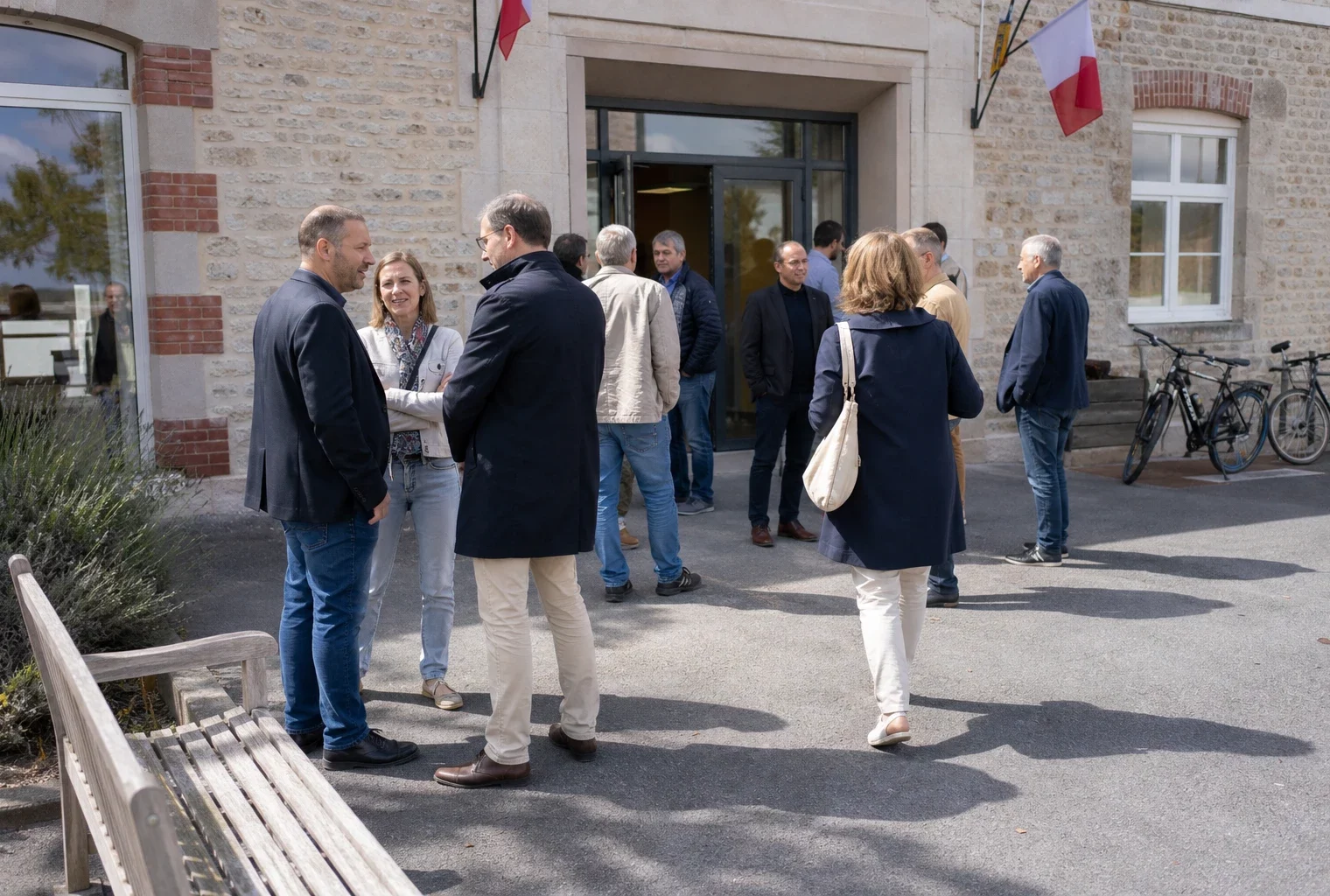 Des citoyens arrivent devant une mairie de quartier lors d’une permanence locale, dans une lumière de journée claire.