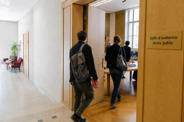 Hall institutionnel français ouvrant sur une salle d’audition préparée pour une assemblée citoyenne sur le climat