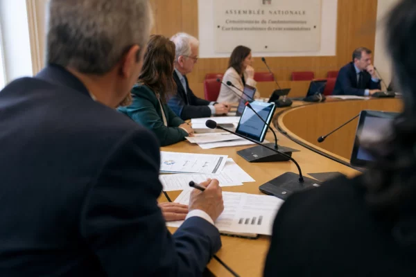 Réunion de commission parlementaire sur la cybersécurité du fisc, avec micros, dossiers et participants anonymes