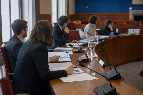 Réunion de commission parlementaire française sur le budget 2027, avec micros et dossiers autour d’une table