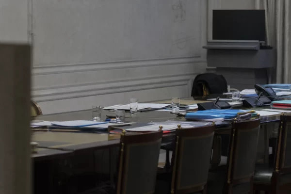 Salle de réunion institutionnelle avec table et chaises, évoquant une consultation politique à l’Élysée.