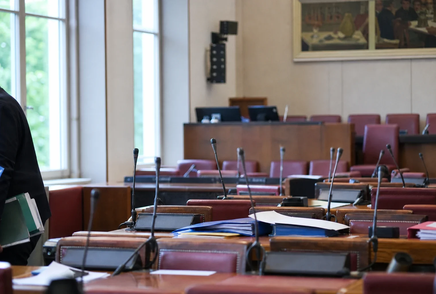 La salle de la commission des Finances à l’Assemblée nationale, avec pupitres, micros et dossiers de séance